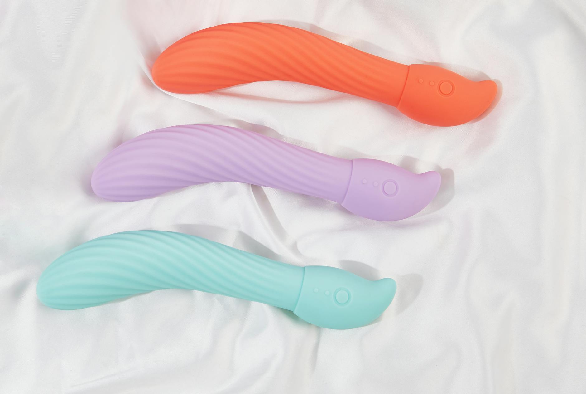 A young couple standing together indoors, exploring shared intimacy with a vibrator