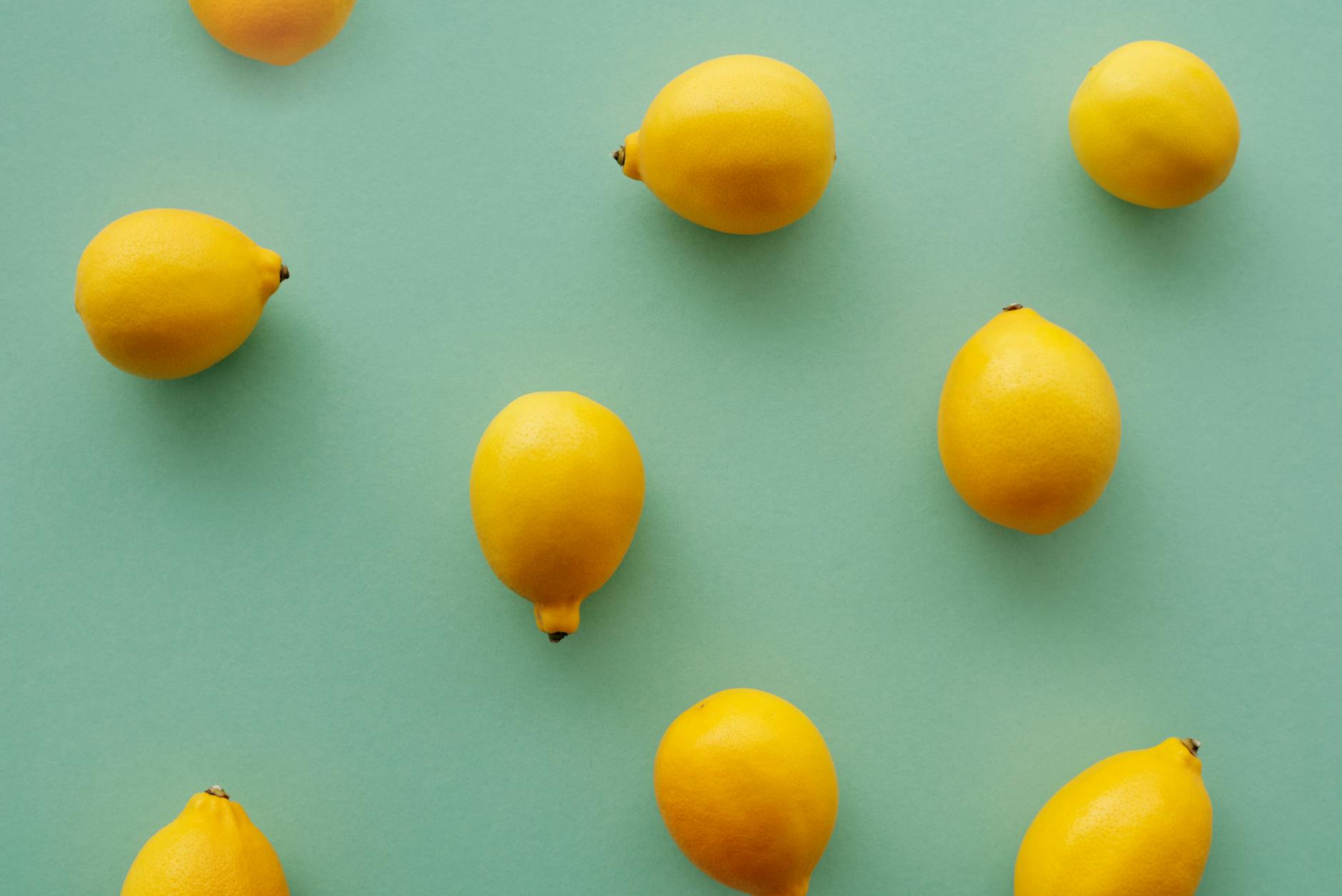 Fresh yellow lemons arranged on a soft green background, symbolizing vulnerability and new beginnings in intimate partnerships