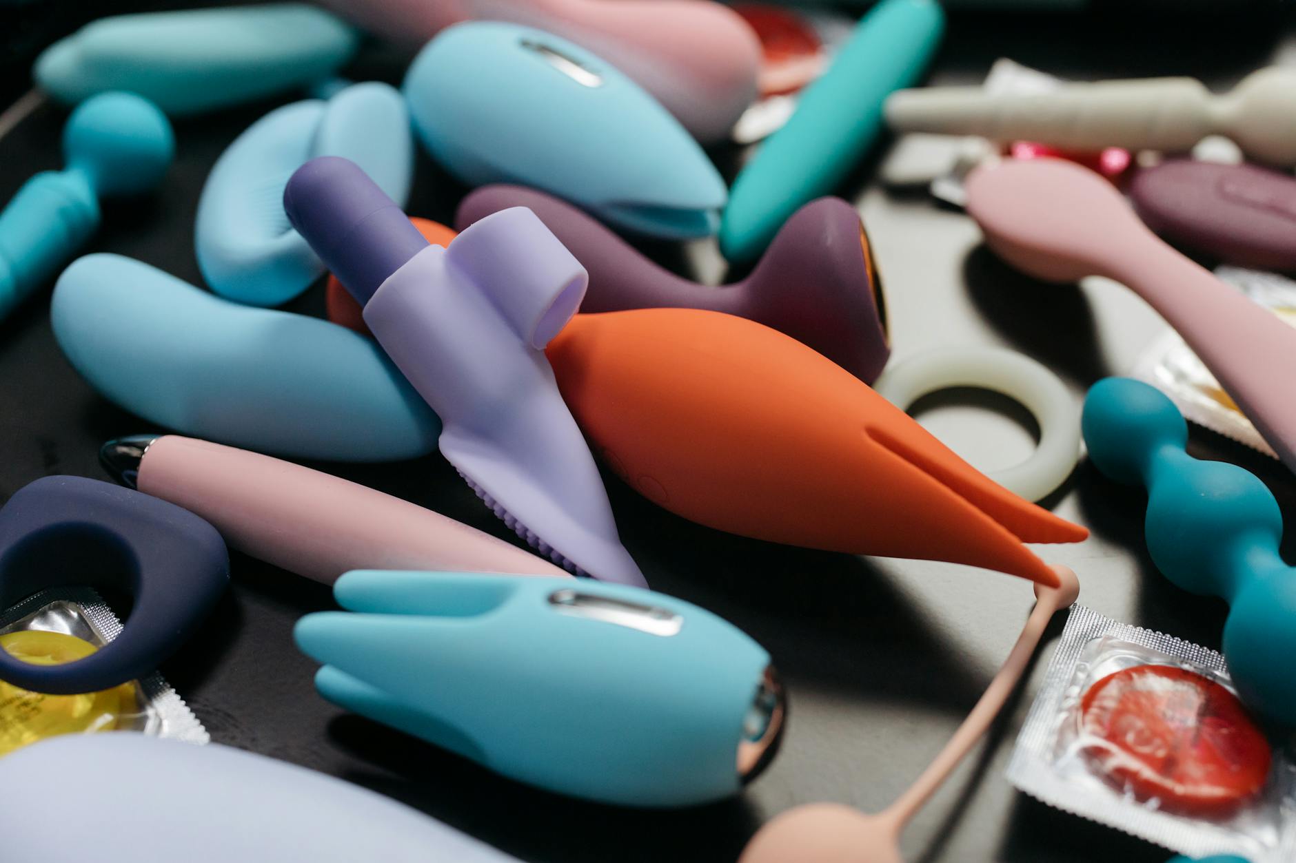 Close-up of hands holding a blue personal massager against a knitted sweater.